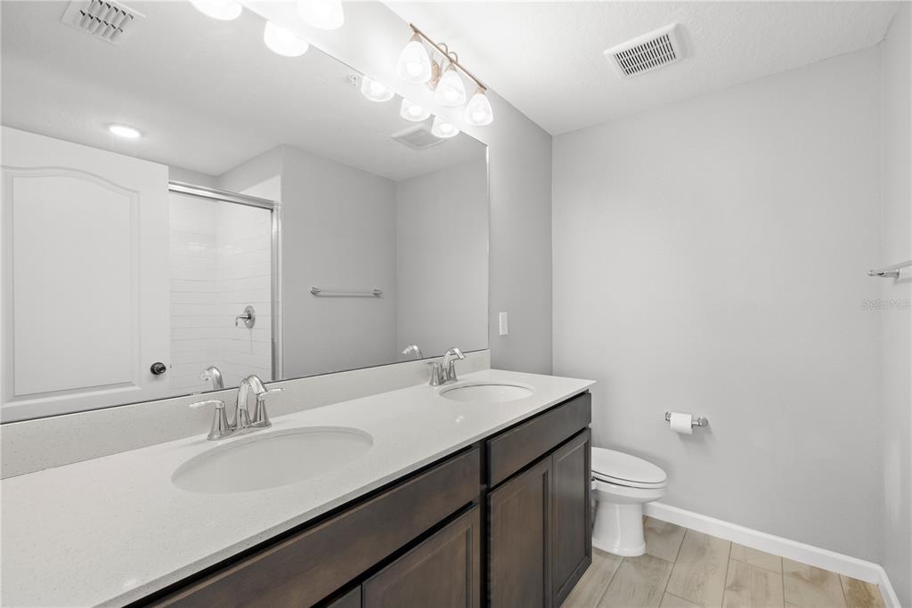 260 Smugglers Way Apopka, FL 32712 - Photo 24 of 34 a bathroom with a sink a toilet and a mirror