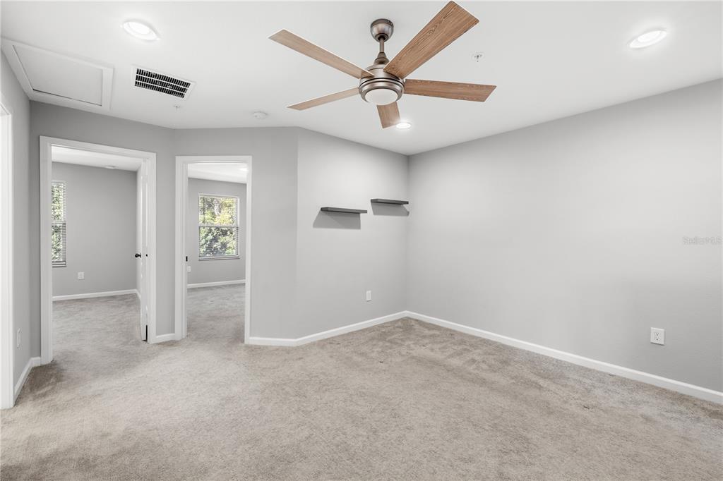 260 Smugglers Way Apopka, FL 32712 - Photo 25 of 34 an empty room with closet and a ceiling fan