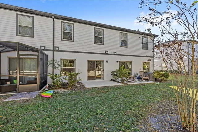 a view of a swimming pool with a lounge chair and palm trees