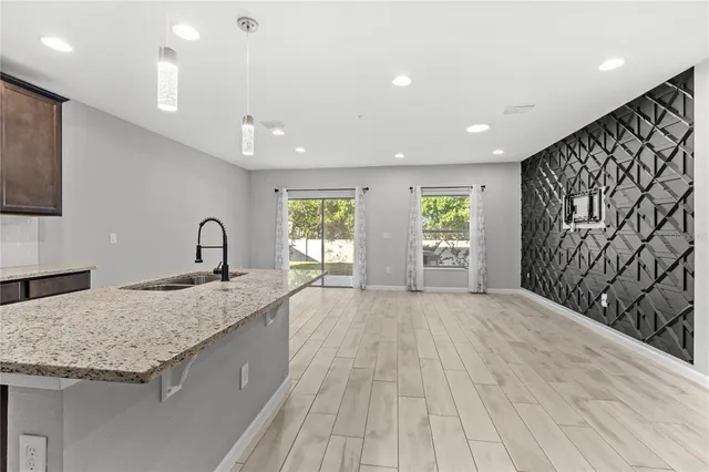 a large kitchen with stainless steel appliances granite countertop a sink and a granite counter tops