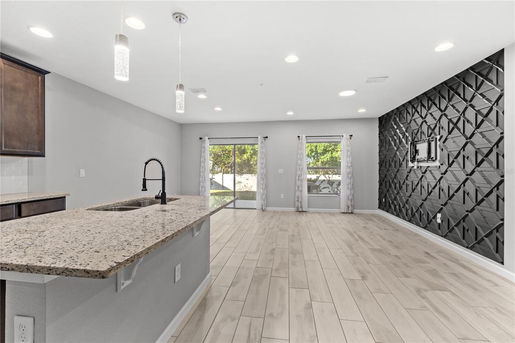 260 Smugglers Way Apopka, FL 32712 - Photo 4 of 34 a large kitchen with stainless steel appliances granite countertop a sink and a granite counter tops