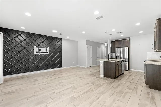 a view of kitchen with refrigerator microwave and wooden floor