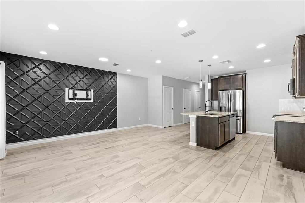 260 Smugglers Way Apopka, FL 32712 - Photo 5 of 34 a view of kitchen with refrigerator microwave and wooden floor
