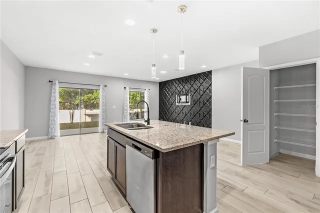 a kitchen with a stove a sink a refrigerator and a refrigerator