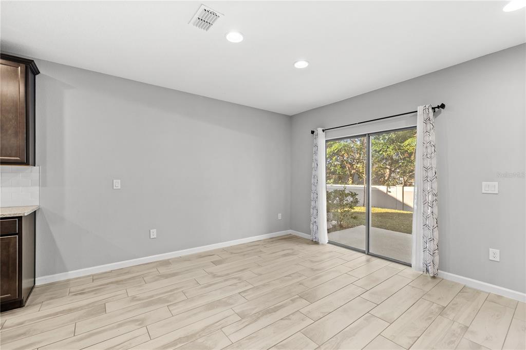 260 Smugglers Way Apopka, FL 32712 - Photo 10 of 34 a view of an empty room with wooden floor and a window