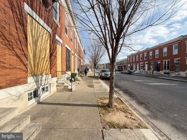 a view of a building with cars parked