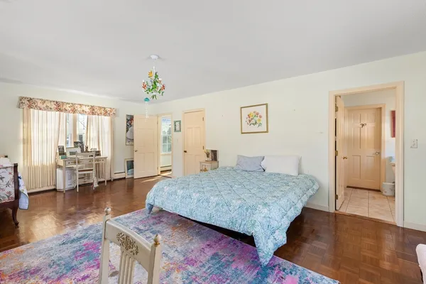 a bedroom with a bed and a potted plant