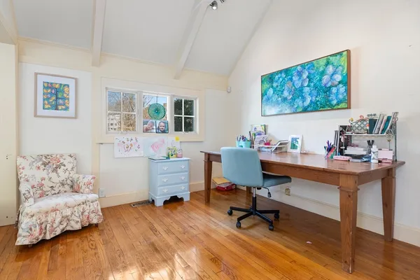a living room with furniture potted plant and a large window