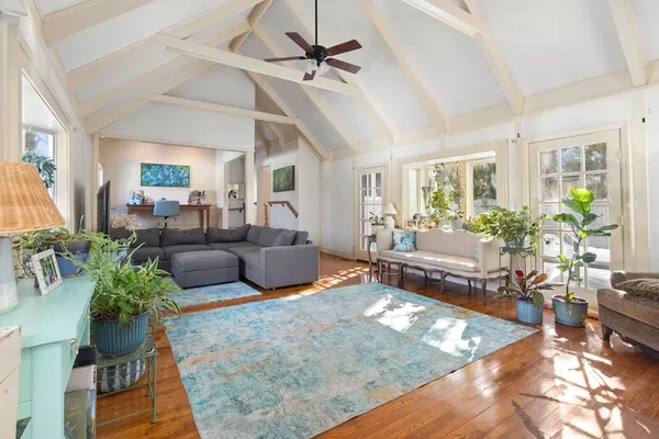 a living room with furniture a fireplace and a flat screen tv