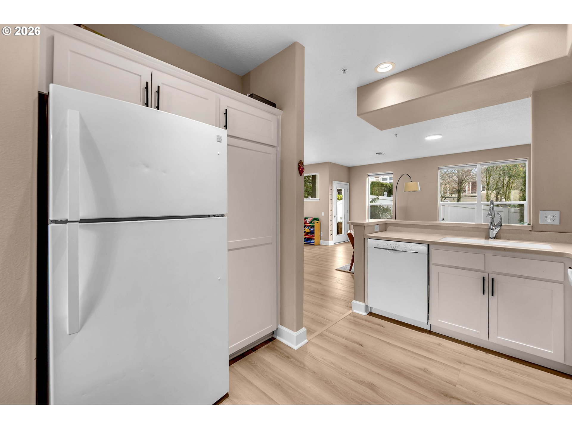 2974 Northwest Kennedy Court, Unit 1 Portland, OR 97229 - Photo 12 of 37 a kitchen with a refrigerator and a sink