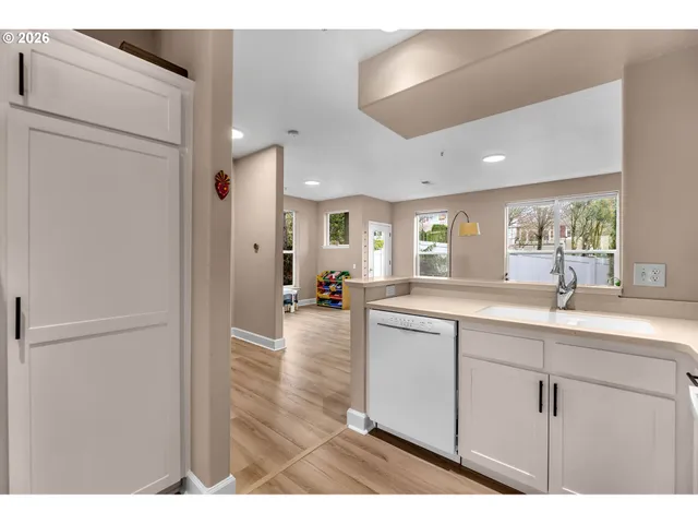 a open kitchen with sink and cabinets