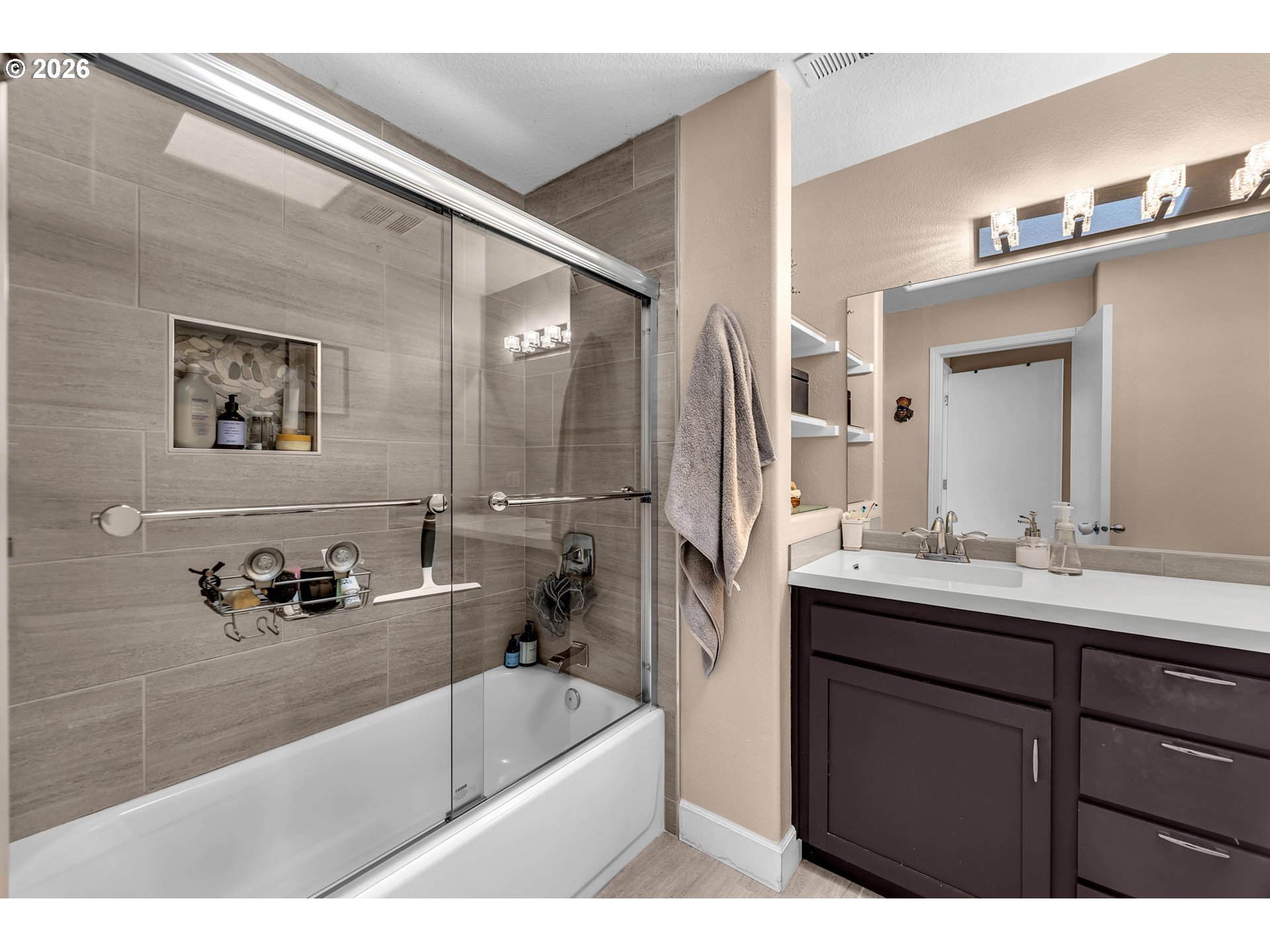 2974 Northwest Kennedy Court, Unit 1 Portland, OR 97229 - Photo 23 of 37 a bathroom with a tub a sink and mirror