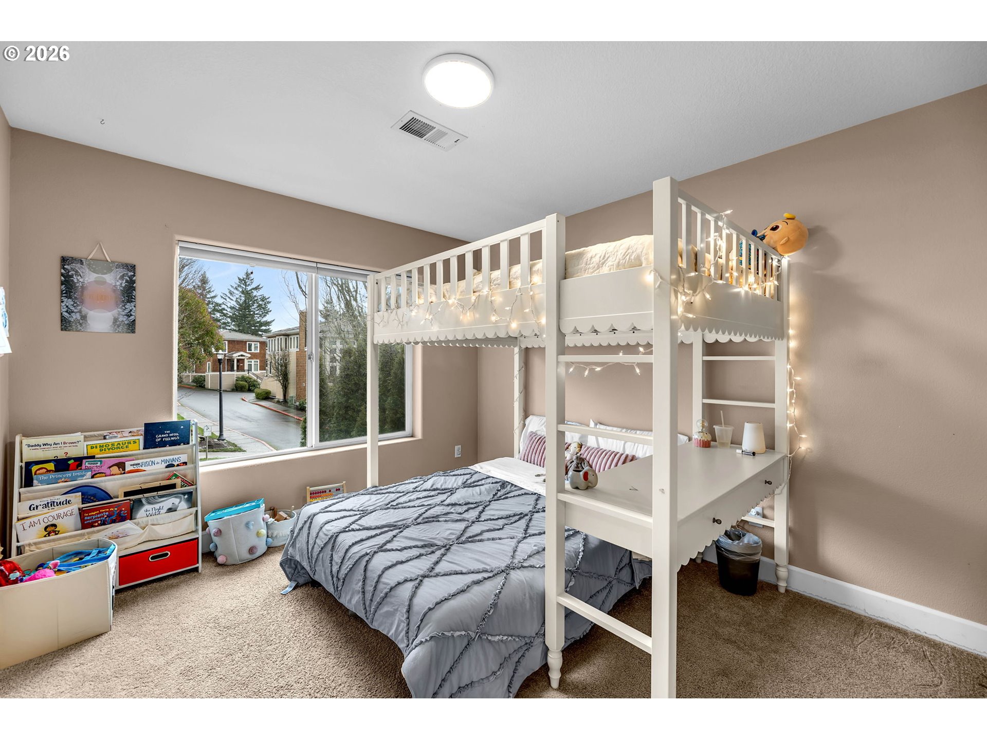 2974 Northwest Kennedy Court, Unit 1 Portland, OR 97229 - Photo 27 of 37 a bedroom with a bed a large window and book shelf