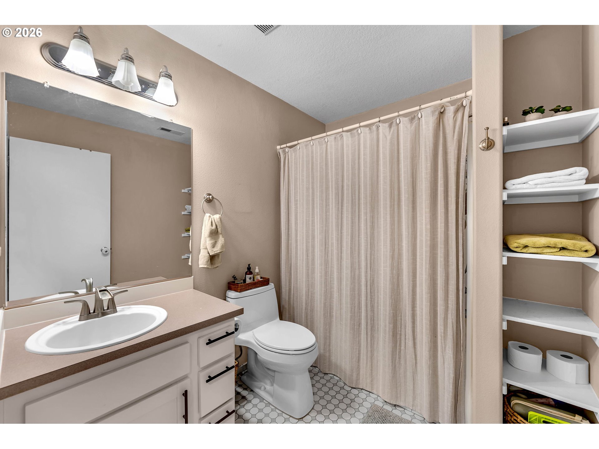 2974 Northwest Kennedy Court, Unit 1 Portland, OR 97229 - Photo 29 of 37 a bathroom with a sink a toilet and shower