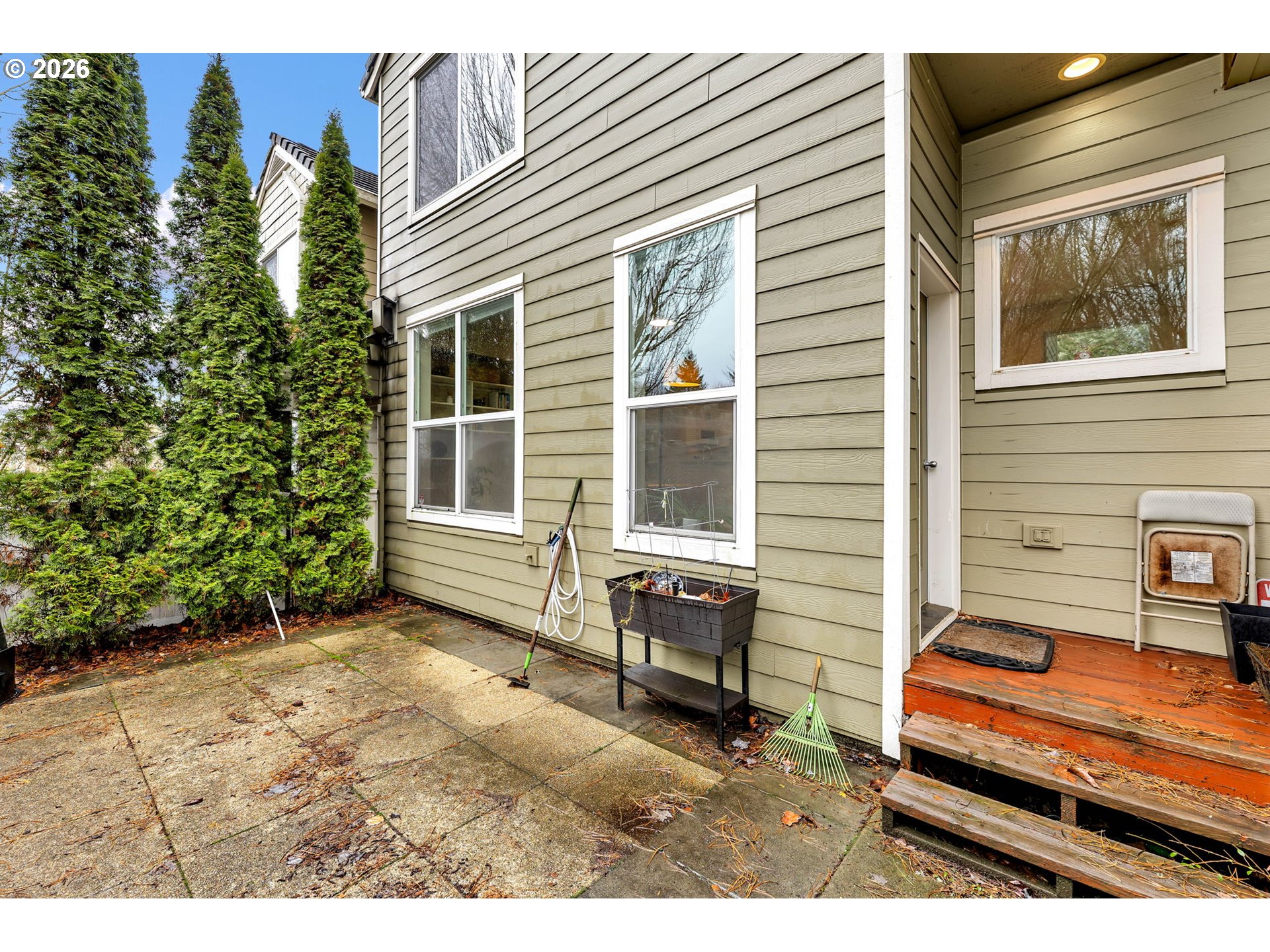 2974 Northwest Kennedy Court, Unit 1 Portland, OR 97229 - Photo 32 of 37 a backyard of a house with barbeque oven table and chairs