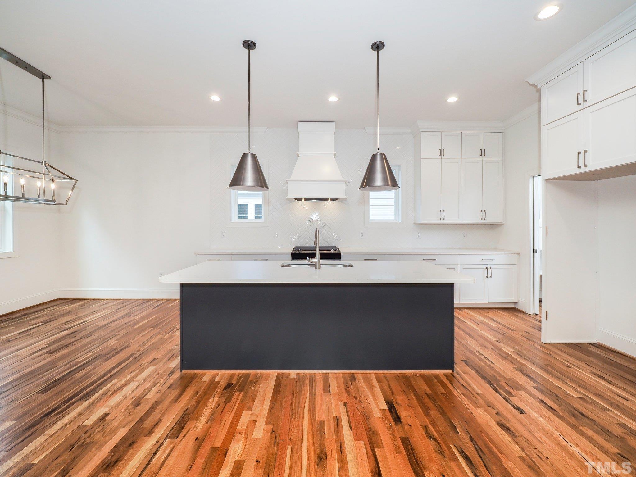 1210 Kent Road Raleigh, NC 27606 - Photo 11 of 30 a view of a kitchen with wooden floor and a sink