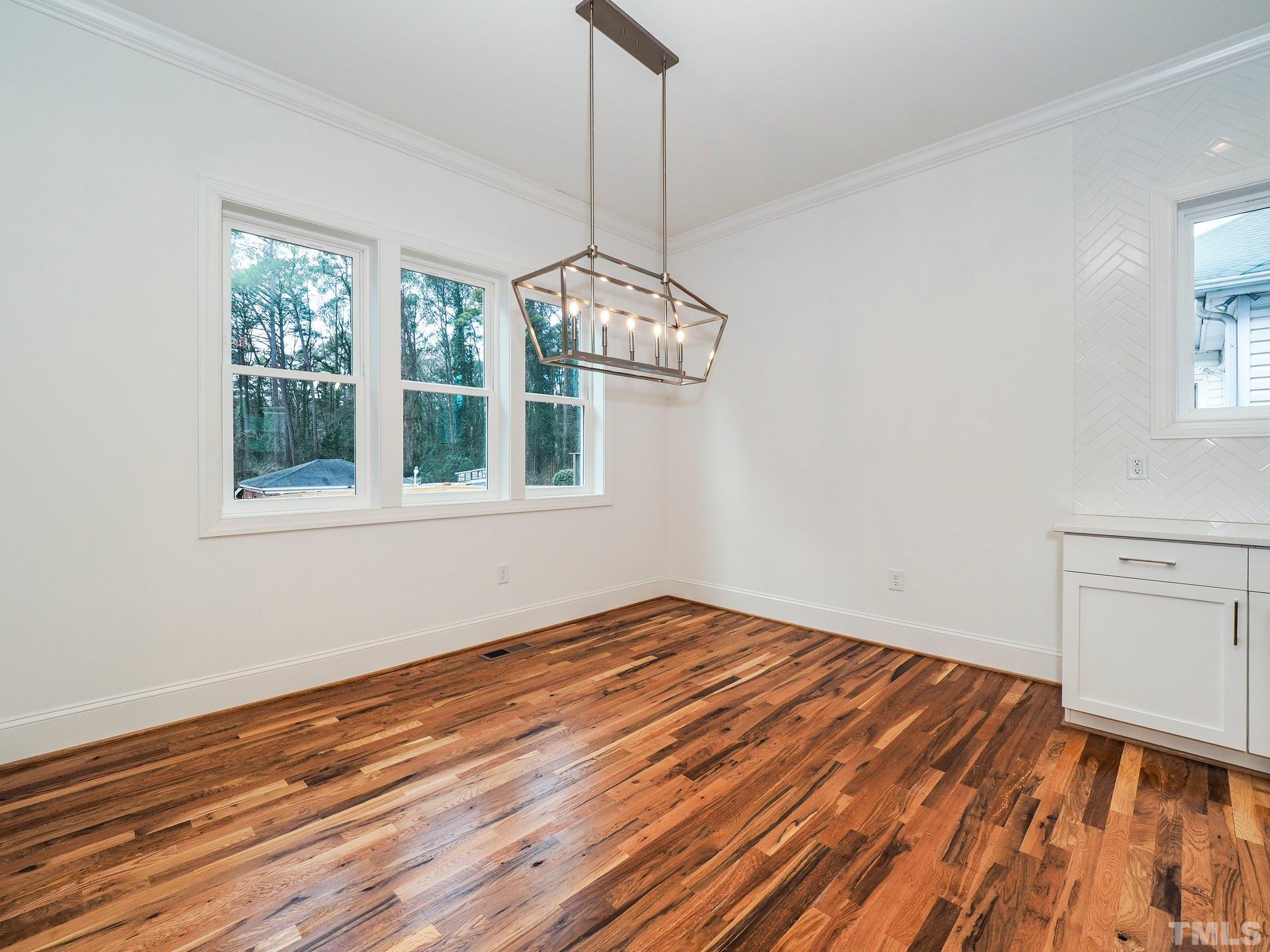 1210 Kent Road Raleigh, NC 27606 - Photo 13 of 30 a view of a room with wooden floor fan and window