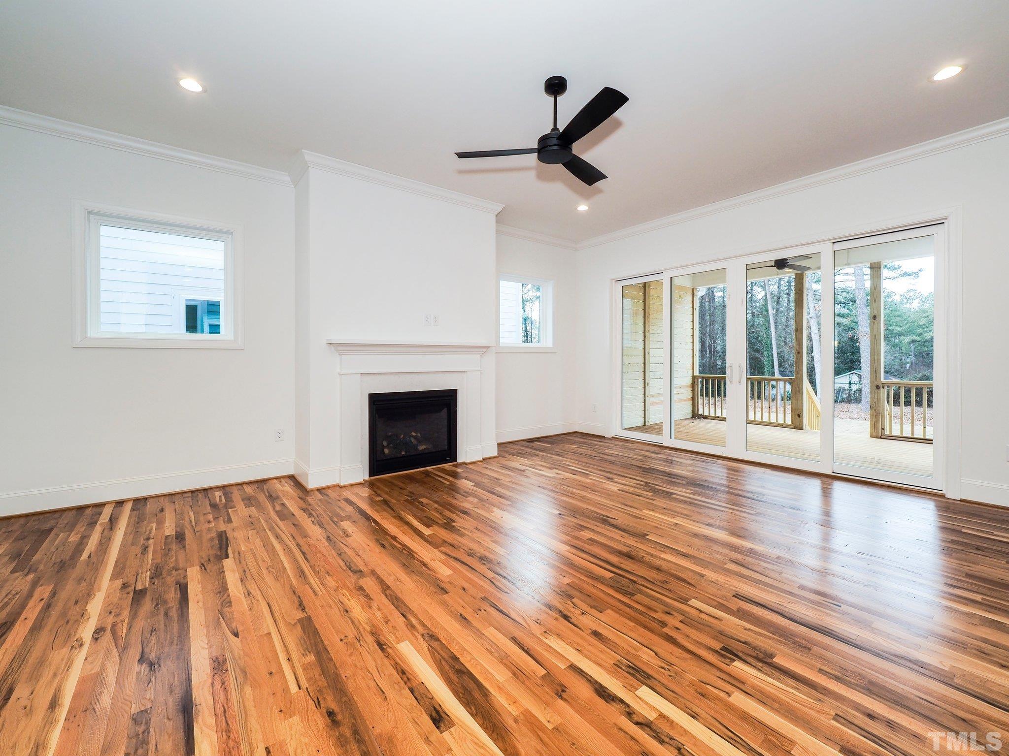 1210 Kent Road Raleigh, NC 27606 - Photo 15 of 30 a view of empty room with wooden floor and fan