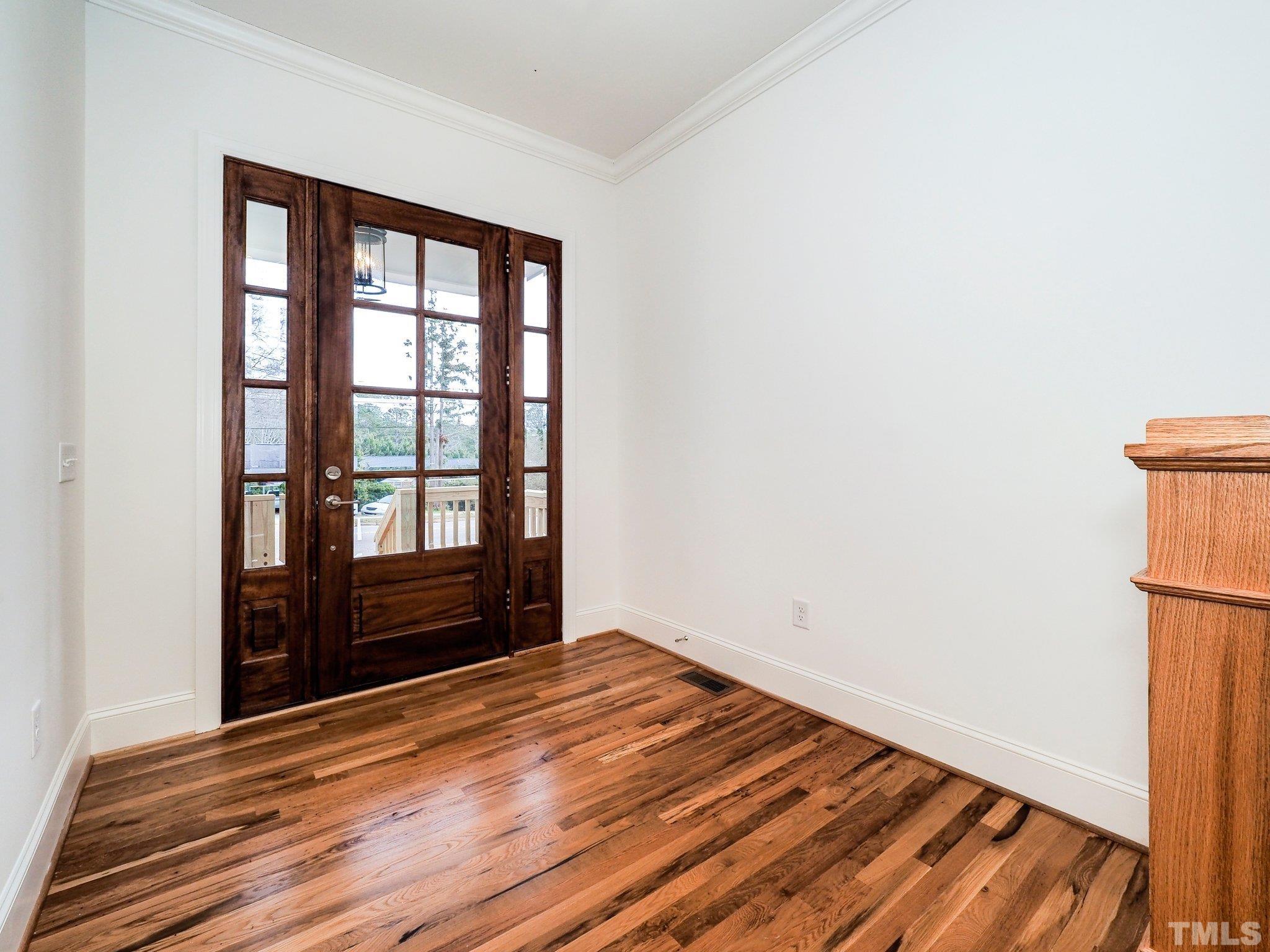 1210 Kent Road Raleigh, NC 27606 - Photo 5 of 30 an empty room with wooden floor and windows