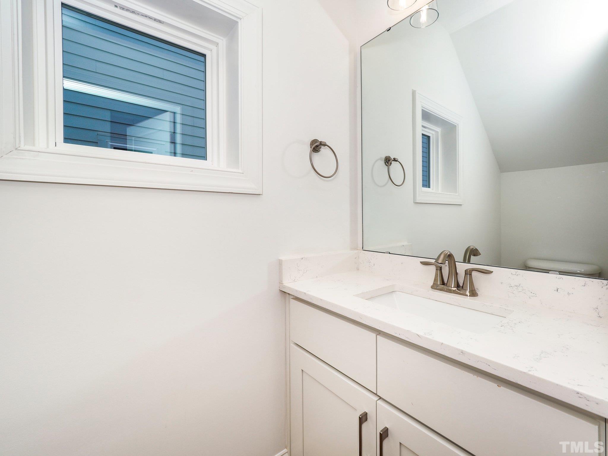 1210 Kent Road Raleigh, NC 27606 - Photo 6 of 30 a bathroom with a sink and a mirror