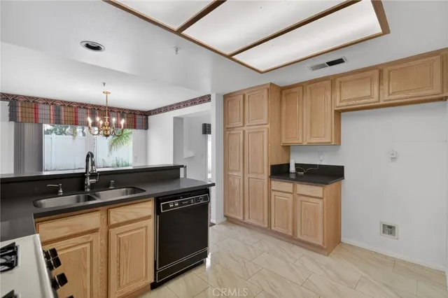 a kitchen with granite countertop a sink cabinets and stainless steel appliances