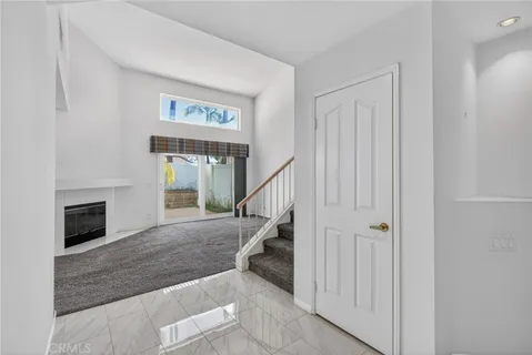 a view of entryway and hall with a fireplace