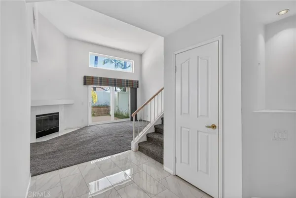 a view of entryway and hall with a fireplace