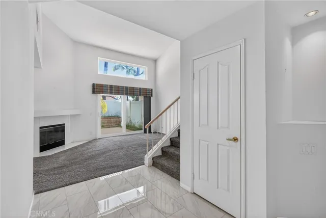 a view of entryway and hall with a fireplace