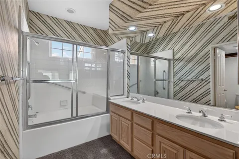 a spacious bathroom with a double vanity sink and mirror