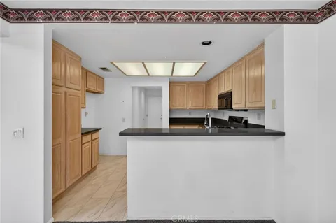 a kitchen with stainless steel appliances a sink a stove and a refrigerator