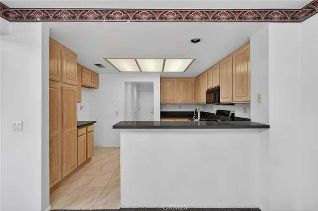 a kitchen with stainless steel appliances a sink a stove and a refrigerator