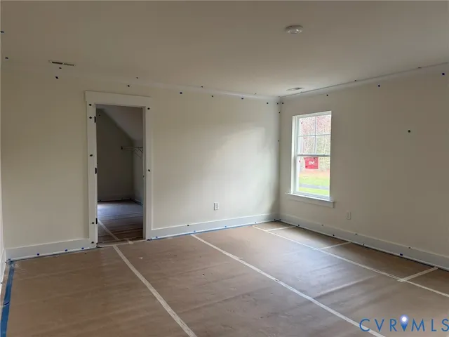 an empty room with window and closet