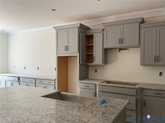 a kitchen with stainless steel appliances granite countertop a sink stove and cabinets