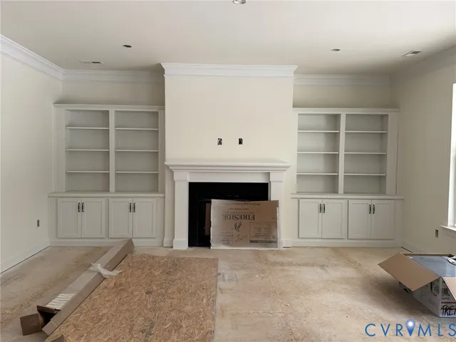 a view of an empty room with a fireplace and a window