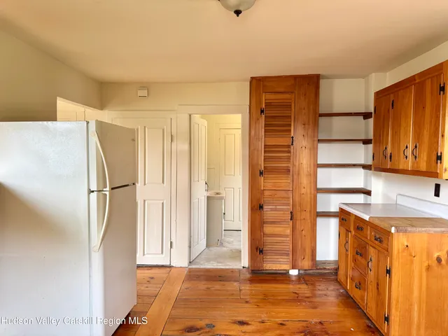 a view of walk in closet with wooden floor