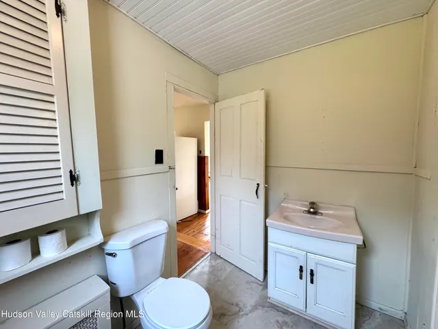 a bathroom with a sink a toilet a mirror and shower