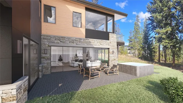 a view of a house with backyard and sitting area