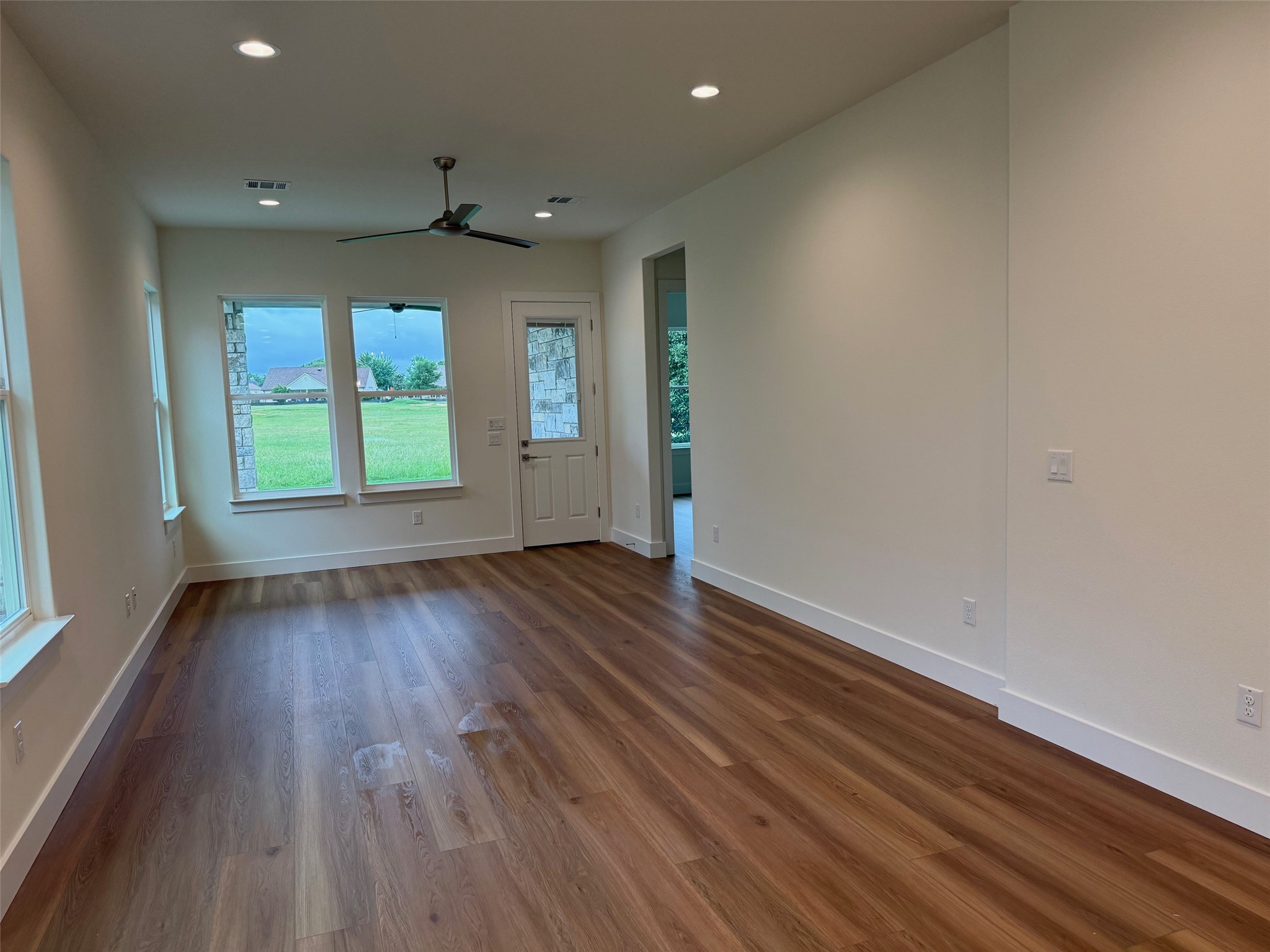 110 Firestone Place Meadowlakes, TX 78654 - Photo 8 of 18 Spacious room featuring wood-finish flooring, white baseboards, and neutral wall tones