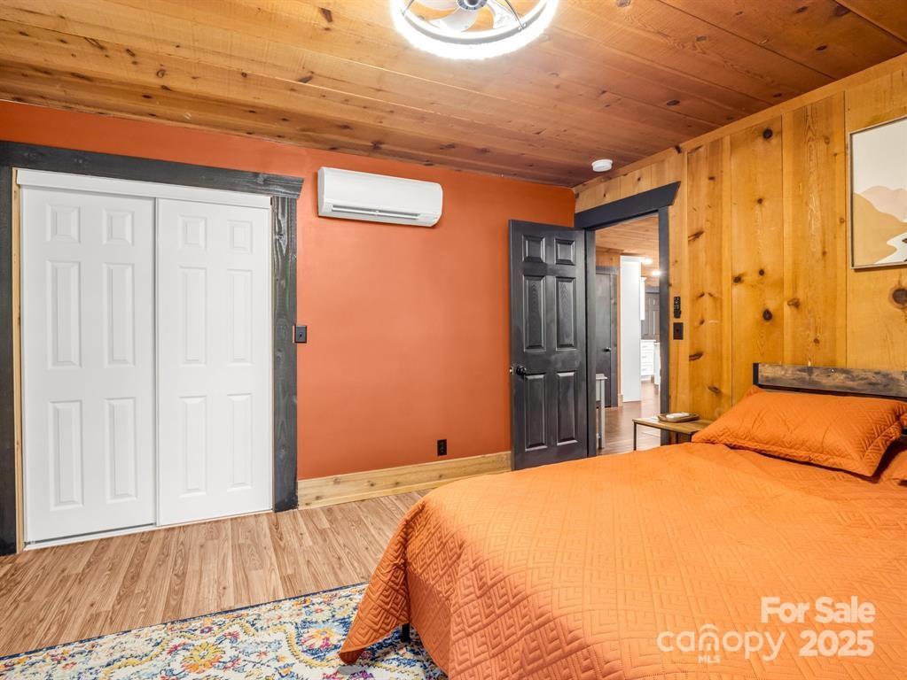 112 Bills Creek Road Lake Lure, NC 28746 - Photo 16 of 42 a bedroom with a bed and a dresser