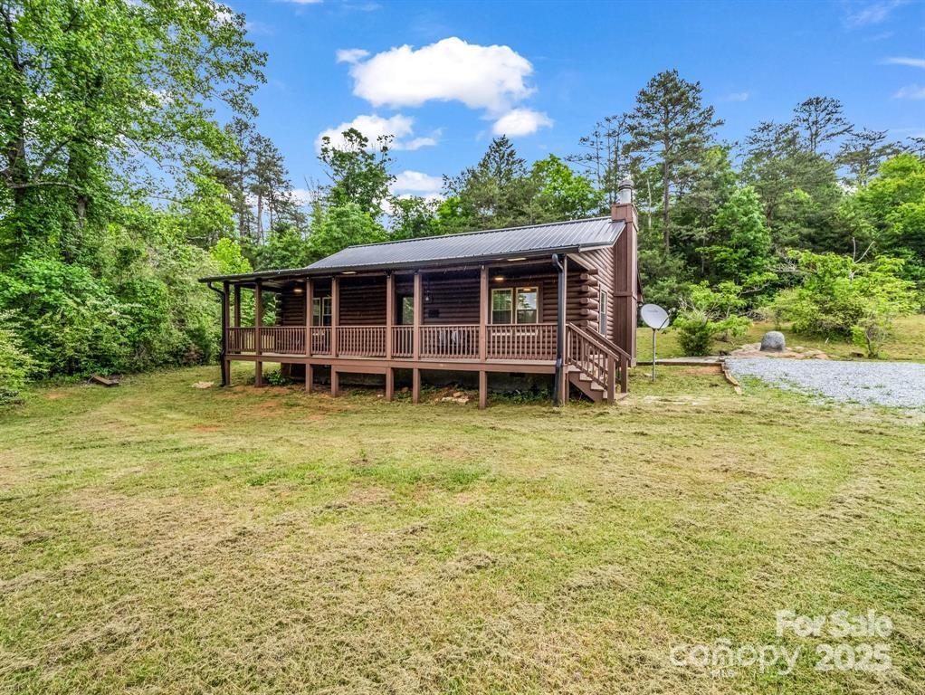 112 Bills Creek Road Lake Lure, NC 28746 - Photo 2 of 42 a view of a house with a backyard