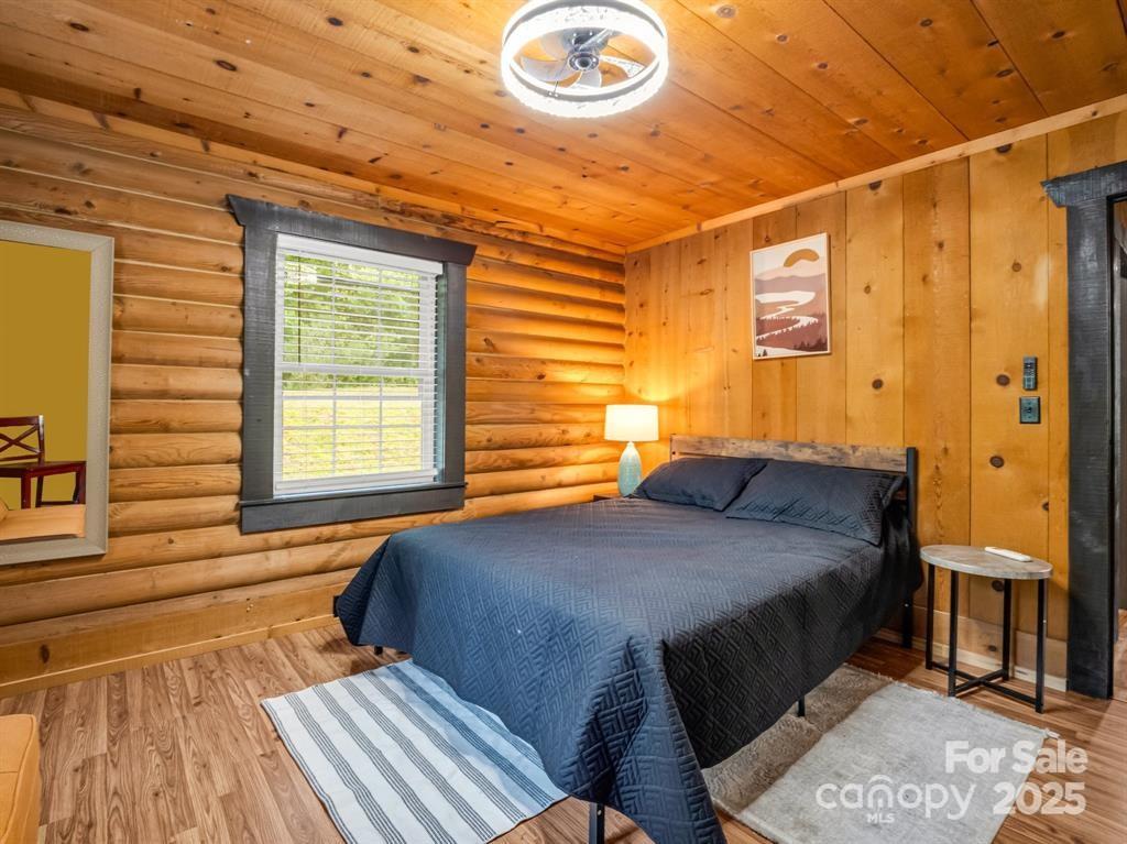 112 Bills Creek Road Lake Lure, NC 28746 - Photo 21 of 42 a bedroom with a bed and a window