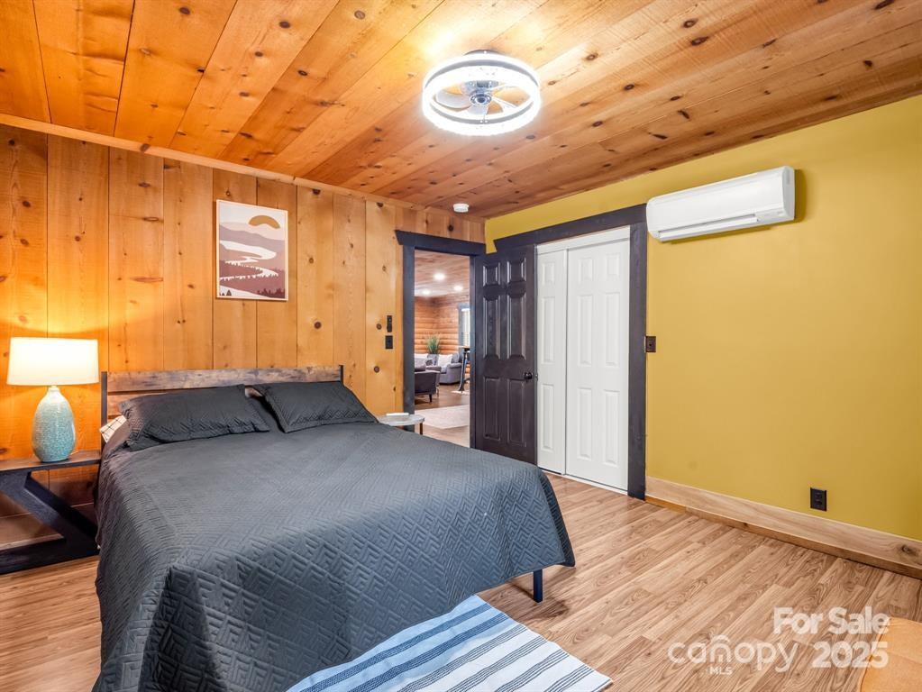 112 Bills Creek Road Lake Lure, NC 28746 - Photo 22 of 42 a bedroom with a bed and a walk in closet