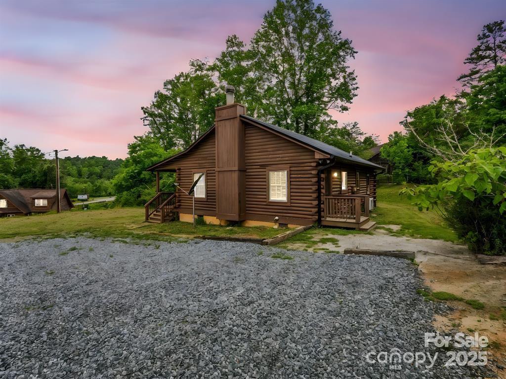 112 Bills Creek Road Lake Lure, NC 28746 - Photo 28 of 42 a view of a house with yard and a tree