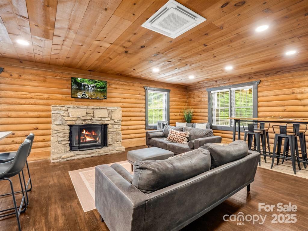 112 Bills Creek Road Lake Lure, NC 28746 - Photo 7 of 42 a living room with furniture a fireplace and a table