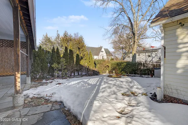 a view of a yard with snow on the road