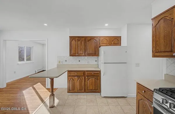 a kitchen with a refrigerator and a stove top oven
