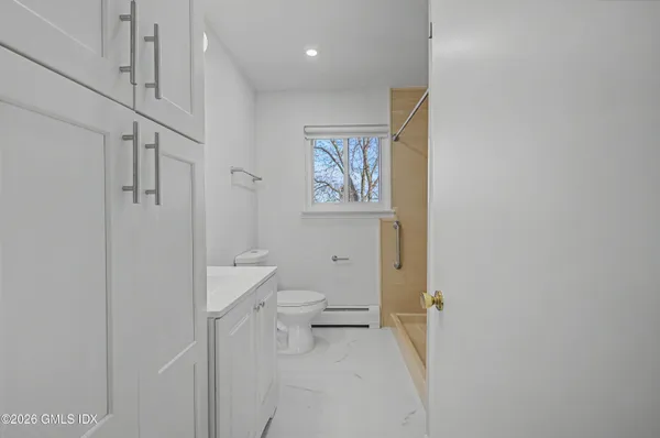 a bathroom with a toilet sink and a shower