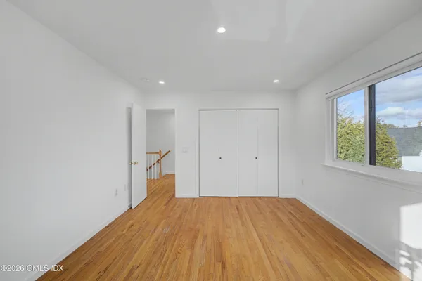 a big room with wooden floor and windows