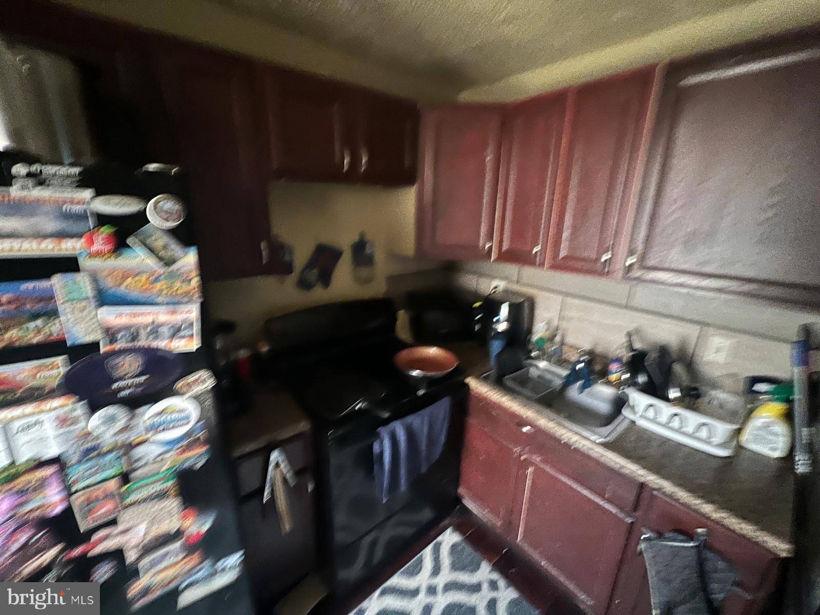 519 Cherry Hill Road Baltimore, MD 21225 - Photo 14 of 20 a kitchen with sink cabinets and appliances