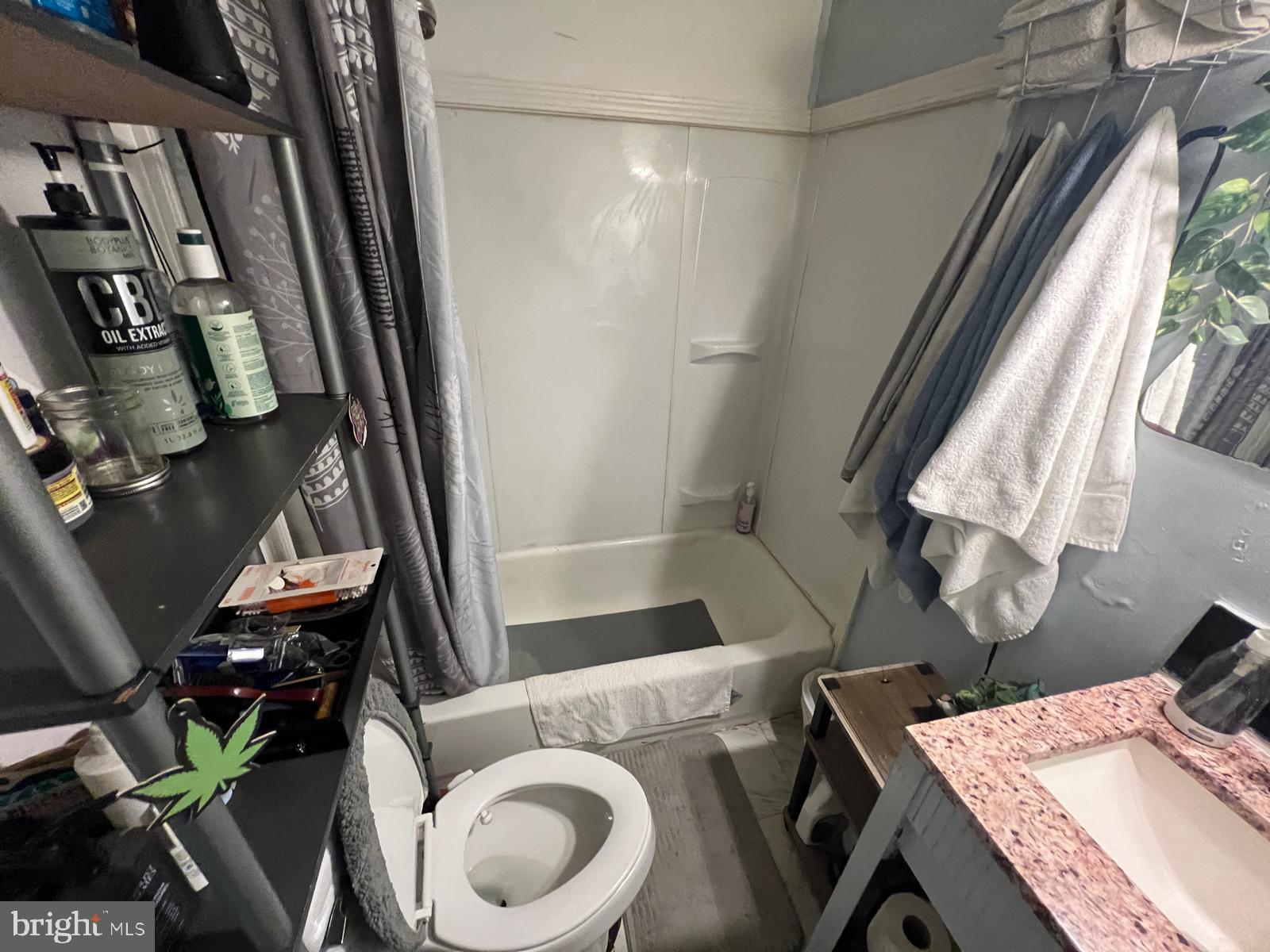 519 Cherry Hill Road Baltimore, MD 21225 - Photo 18 of 20 a bathroom with a sink mirror vanity and toilet